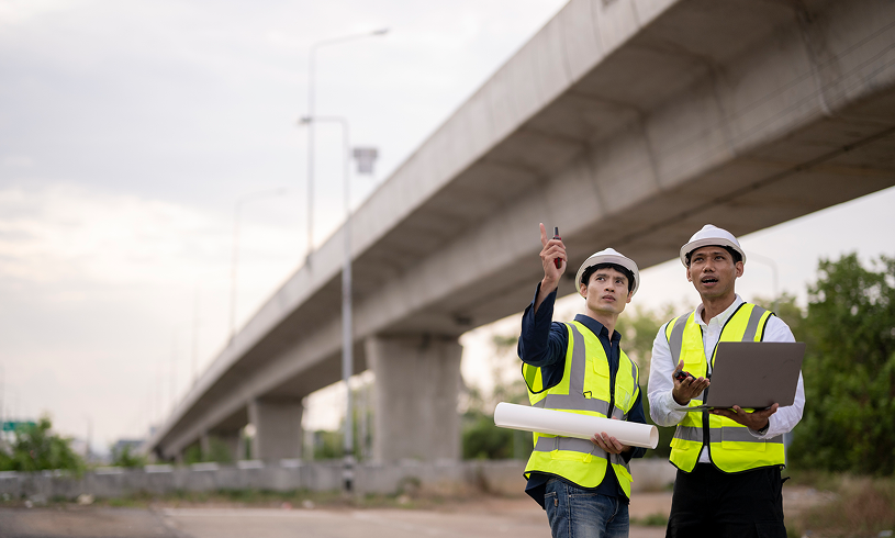 Engineers discussing bridge construction plans