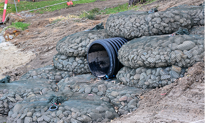 Erosion prevention setup with stacked rock bags