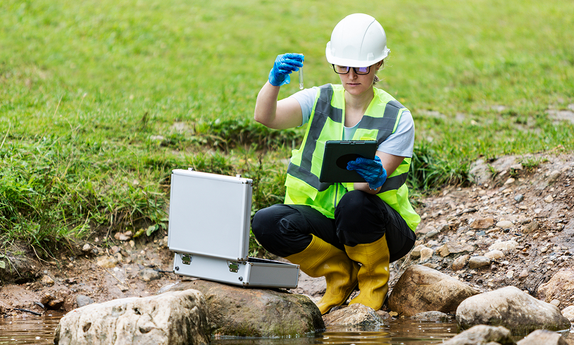 Environmental researcher analyzing water sample