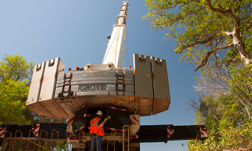 Construction worker inspecting large crane