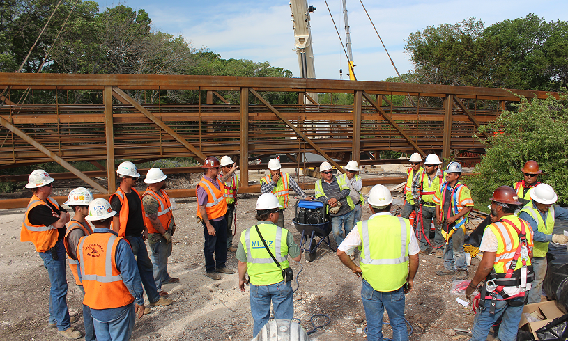 Crew gathering near bridge construction site.