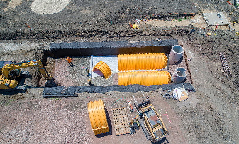 Construction site with large yellow pipes