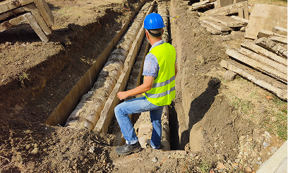 Worker in blue helmet at construction site.