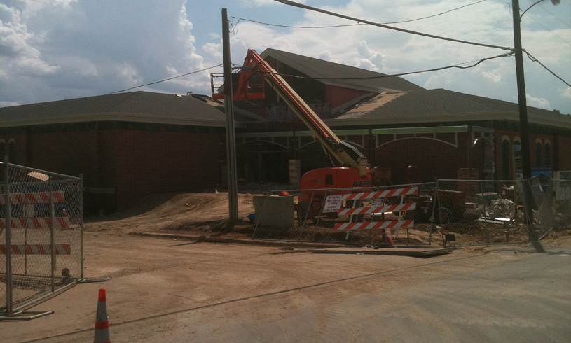 Roadwork in progress near brick building