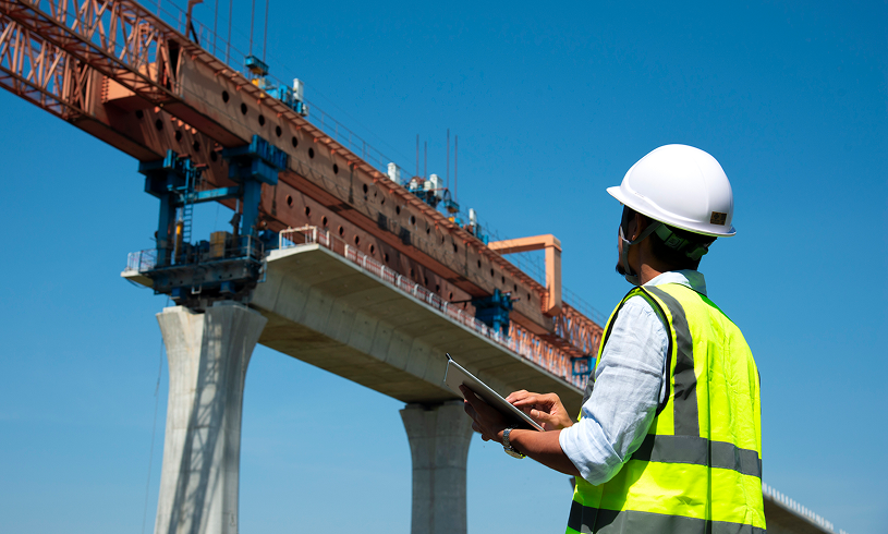 Building site with engineer observing progress