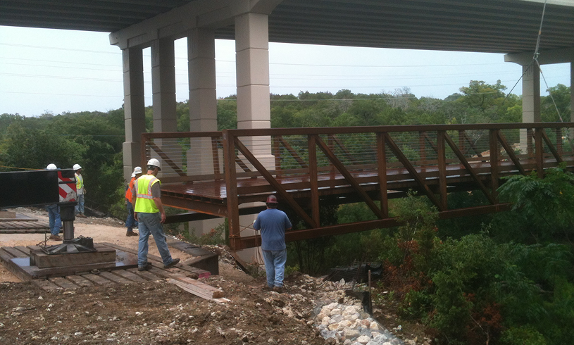 Crew working beside a bridge structure