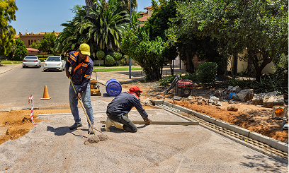 Construction workers paving a street