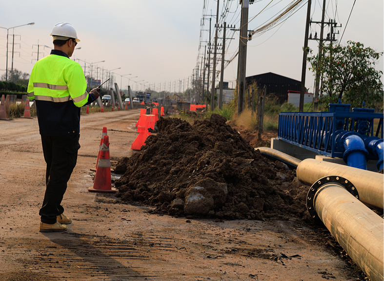 Construction worker inspecting roadwork site
