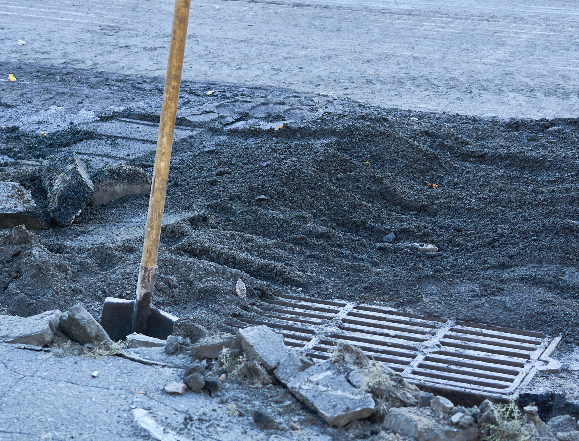 Roadwork with exposed sewer grate