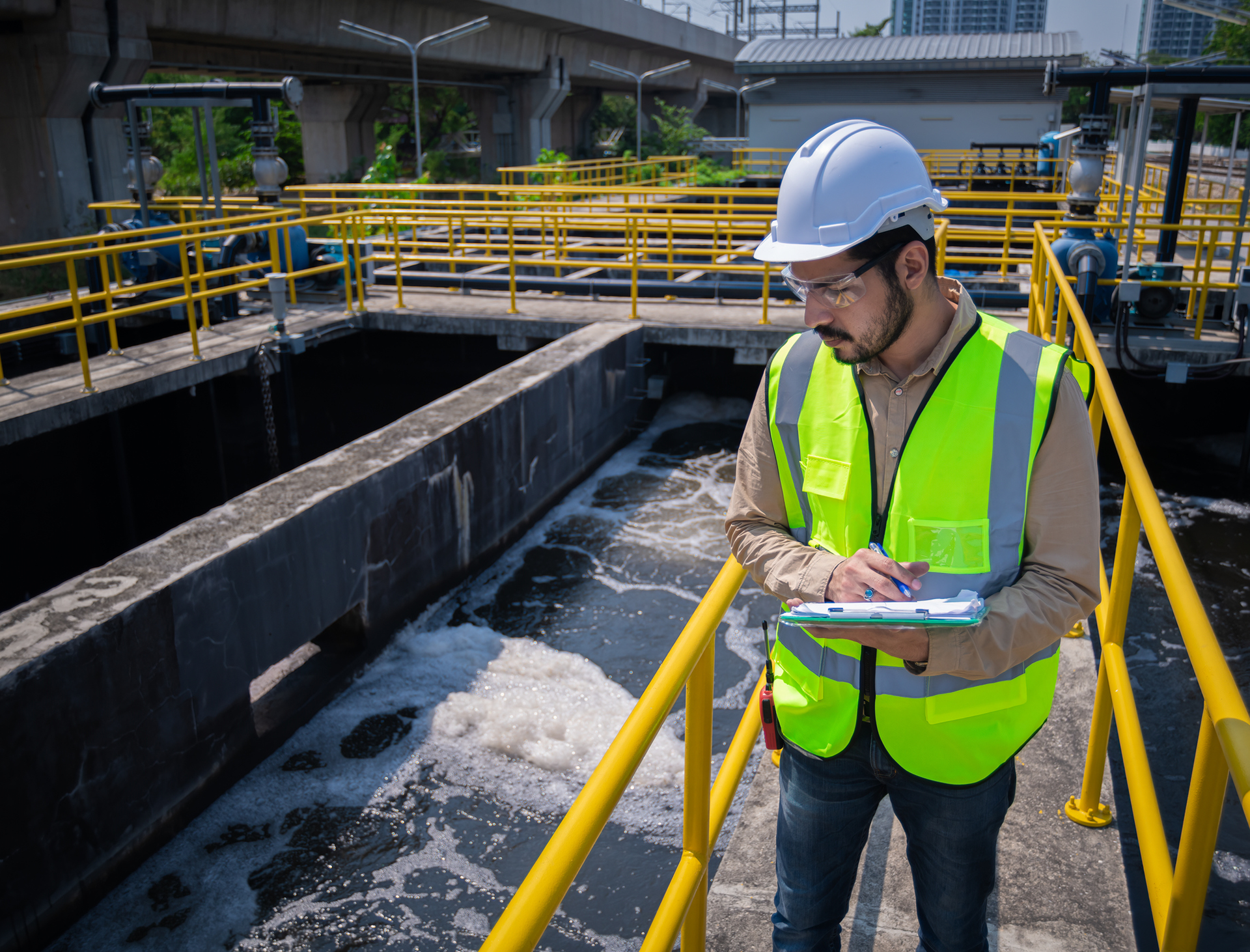 Worker in safety gear at wastewater plant