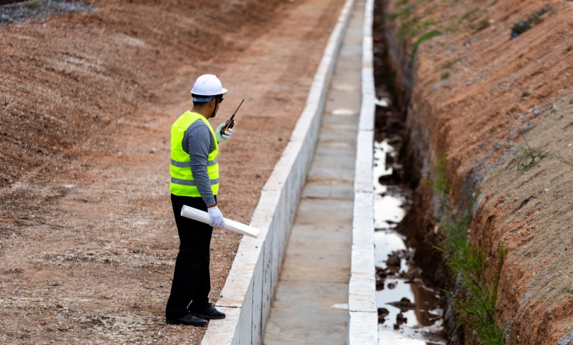 Construction worker using radio at site